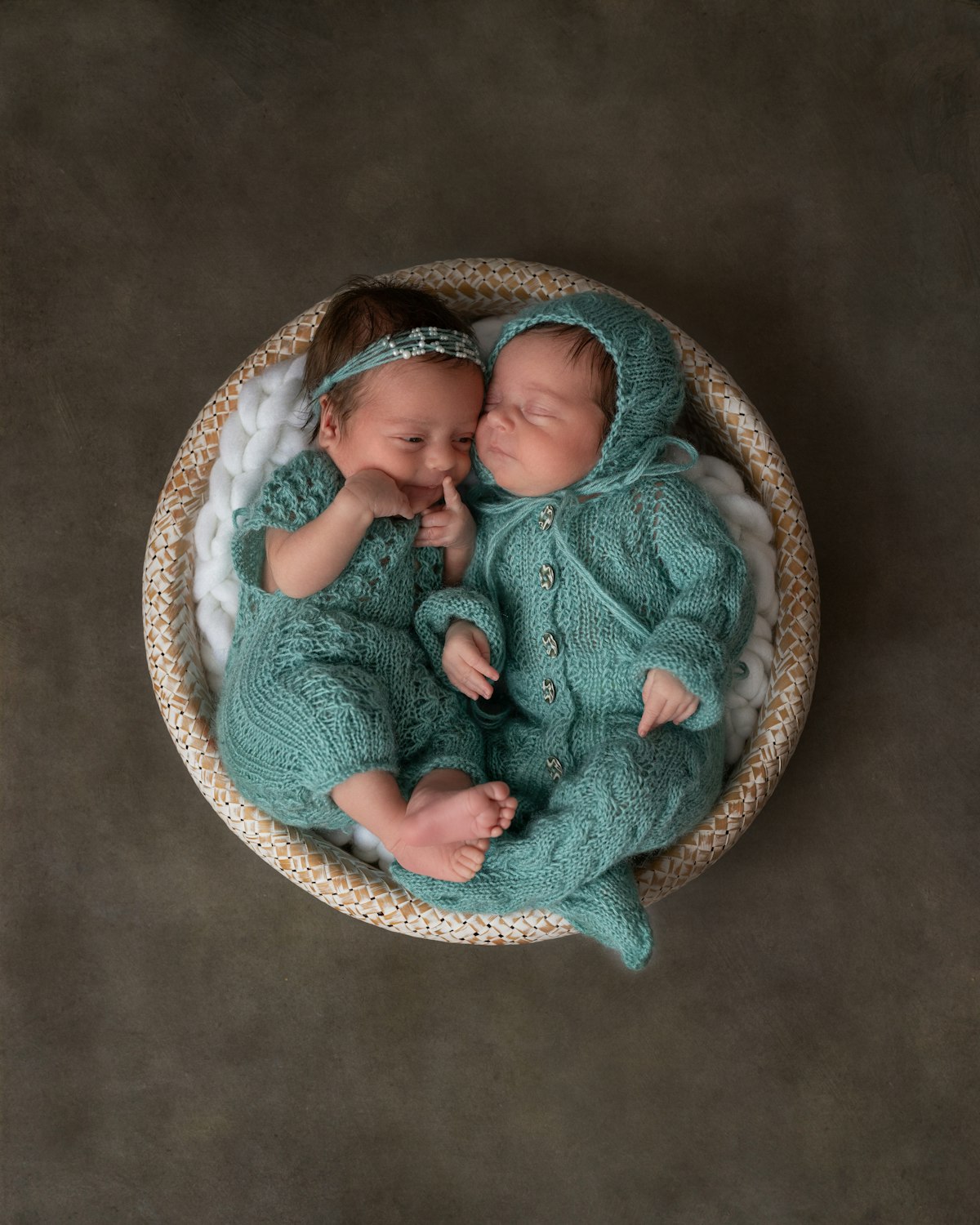 Two babies resting side by side